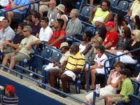 Richard Williams and Venus Williams watching Serena Williams.