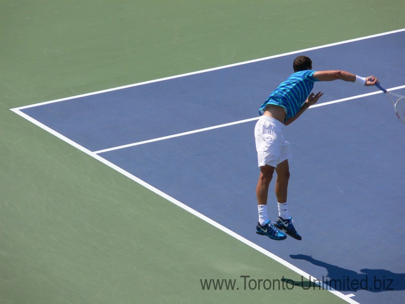Grigor Dimitrov's follow through after hitting the serve. Stadium Court August 9, 2014 Rogers Cup Toronto