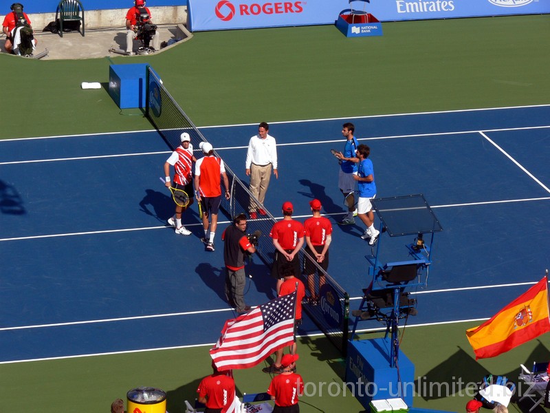 Bob Bryan with Mike Bryan in the left are standing on the court for coin tossup with Marcell Granollers and Marc Lopez, August 12, 2012 Rogers Cup doubles final.