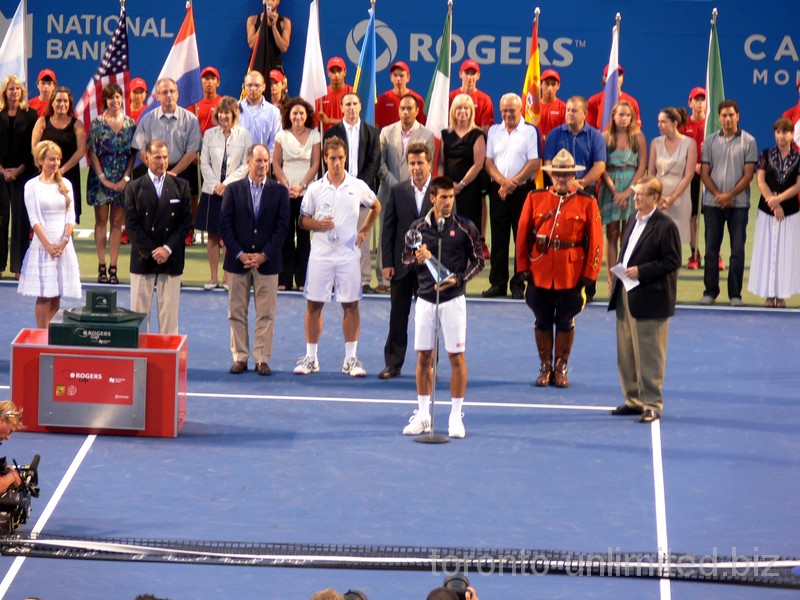 Novak Djokovic is standing with his Championship Trophy. August 12, 2012 Rogers Cup.