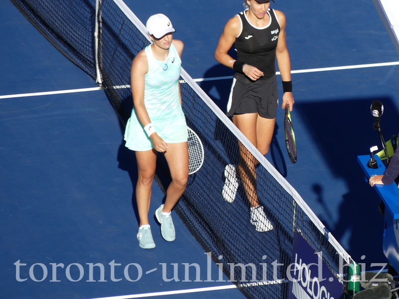 The match is over, and HADDAD MAIA BRA is the winner. Both competitors are walking the shake hand with the Umpire on Stadium Court on August 11, 2022