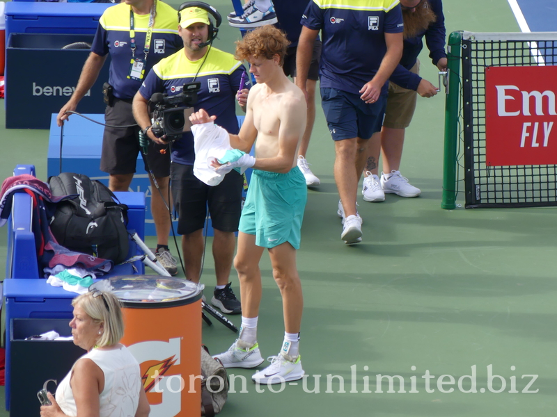 Still shirtless Jannik Sinner before being interviewed by the media.