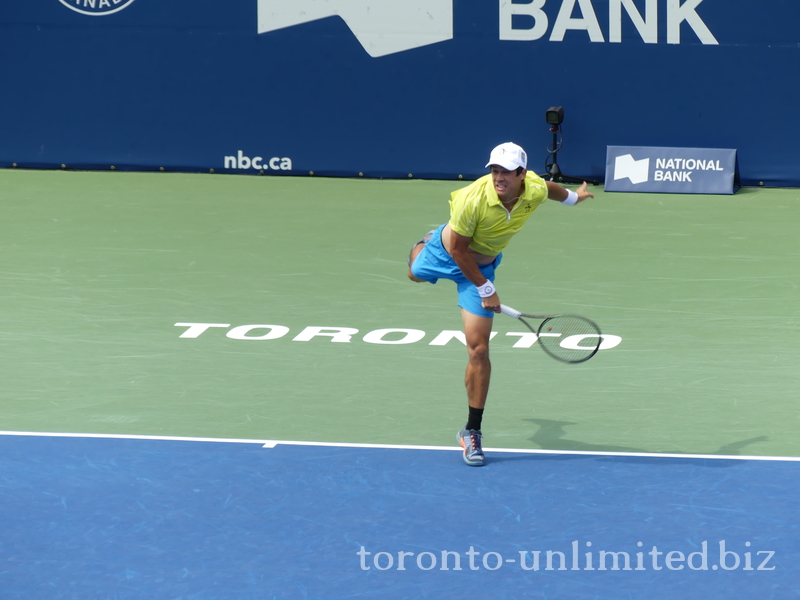 Mackanzie McDonald (USA) serving to Milos Raonic 