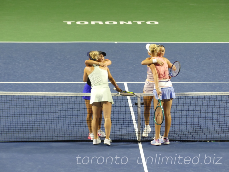 The players are embracing each other and  Caroline Dolehide (USA), Desirae Krawczyk (USA) are the winners